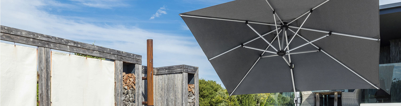 Gray Frankford Cantilever Umbrella shading the pool of a modern home